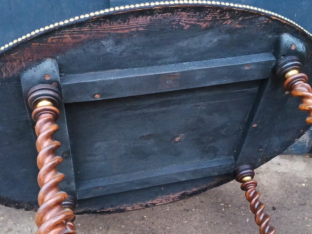An oval antique gaming table featuring a dark baize top trimmed with brass studs, set upon barley-twist legs with a parcel-gilded stretcher base. View IX