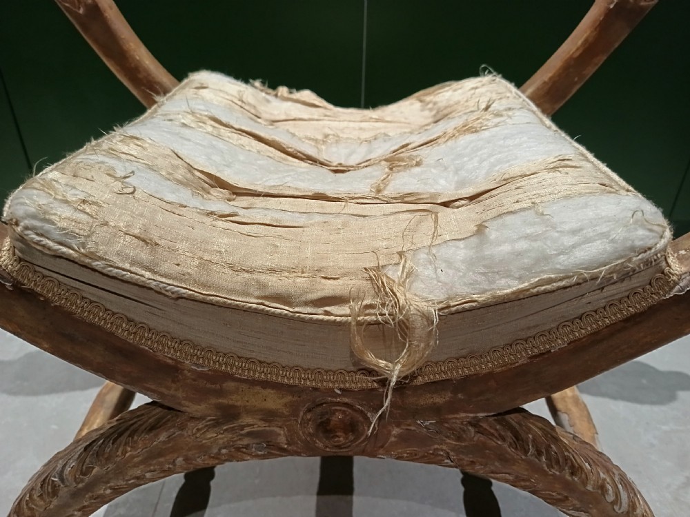 A giltwood curule window seat. View VII