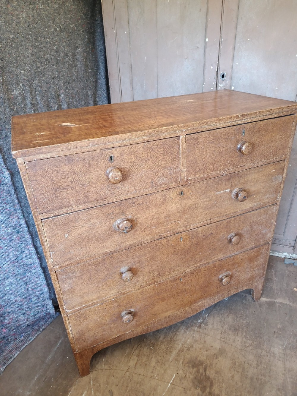 A Regency pine chest of drawers featuring a two-over-three drawer configuration, turned wooden knobs, and a shaped apron bottom. View II