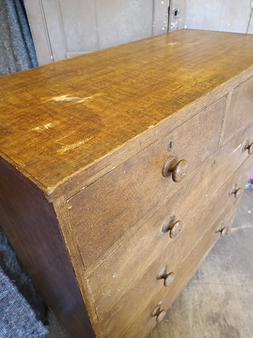 A Regency pine chest of drawers featuring a two-over-three drawer configuration, turned wooden knobs, and a shaped apron bottom. View III