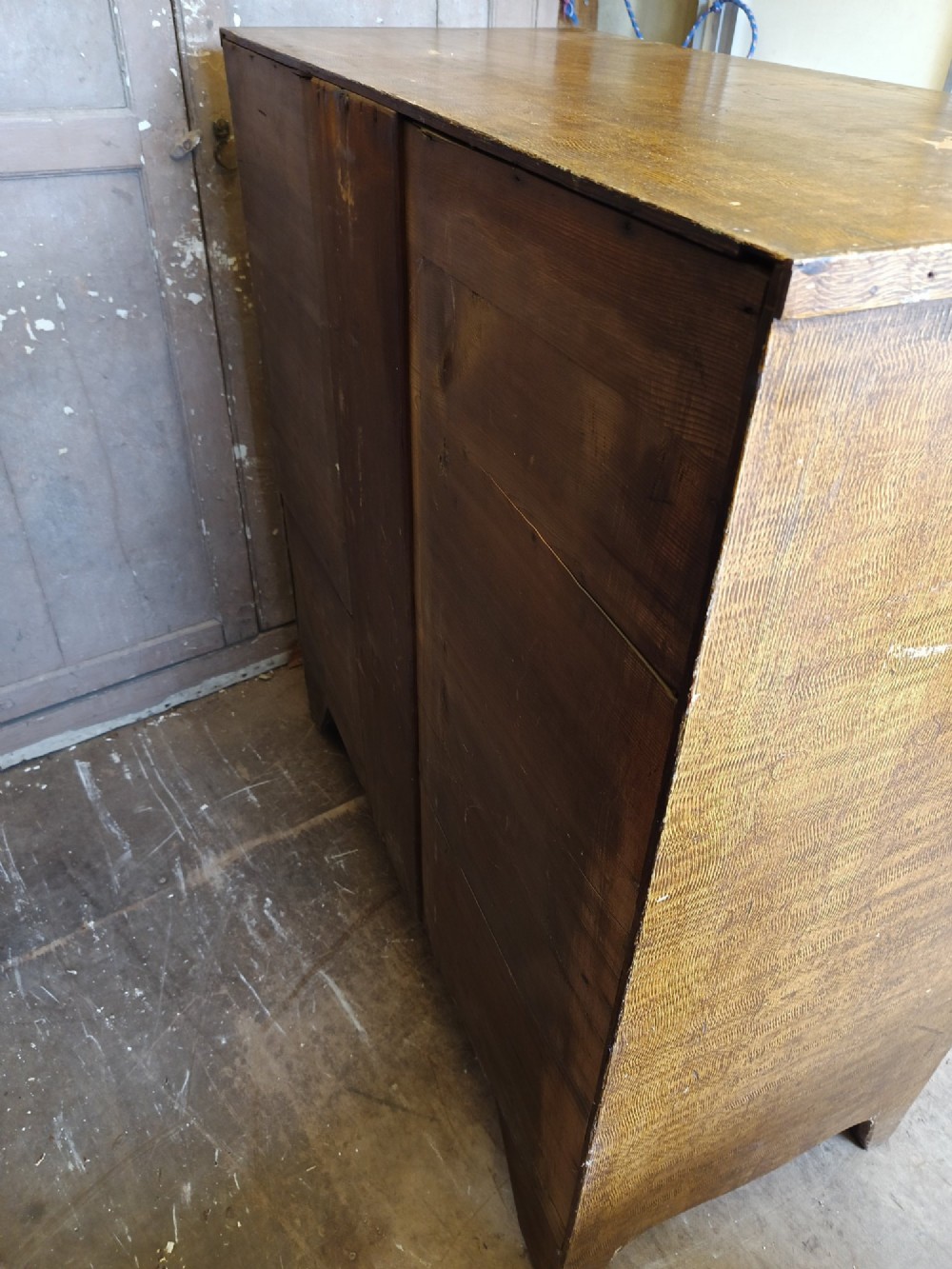 A Regency pine chest of drawers featuring a two-over-three drawer configuration, turned wooden knobs, and a shaped apron bottom. View IV