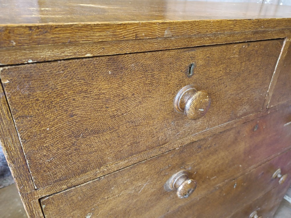A Regency pine chest of drawers featuring a two-over-three drawer configuration, turned wooden knobs, and a shaped apron bottom. View V