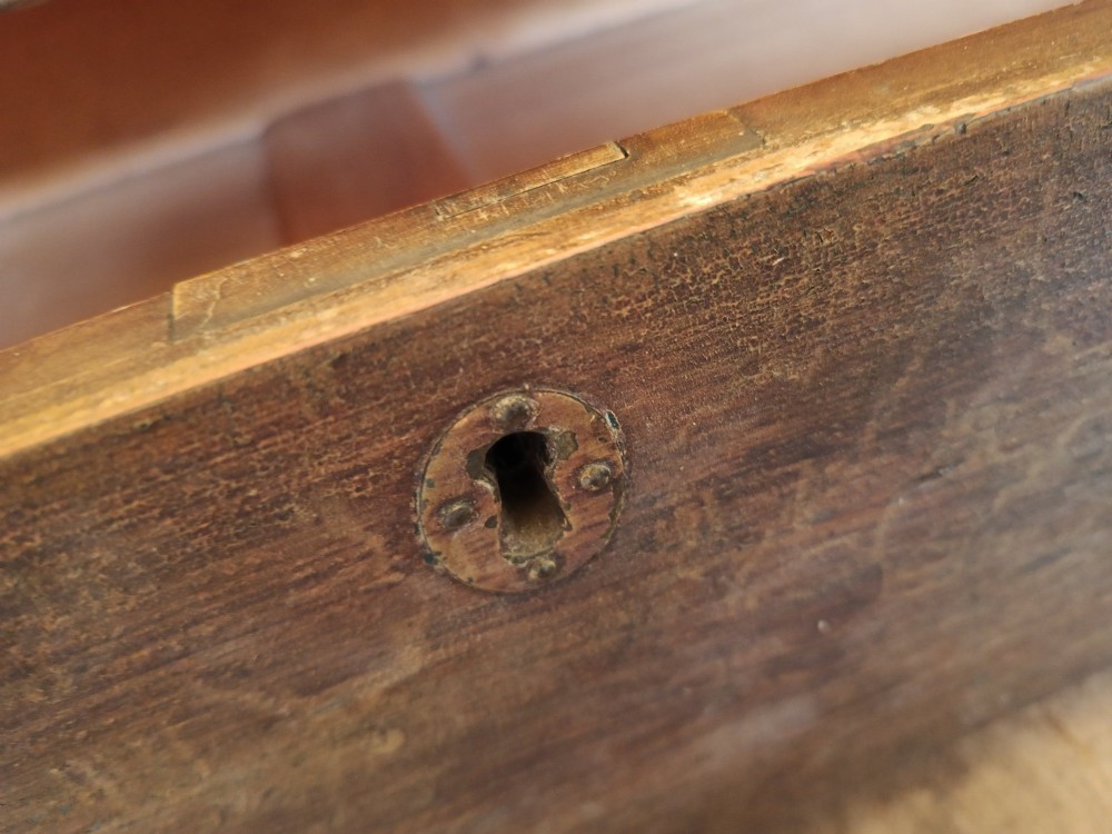 An early 19th-century painted pine mule chest featuring a top hinged coffer lid, a single lower drawer with two turned wooden knobs, and keyhole escutcheons. View III