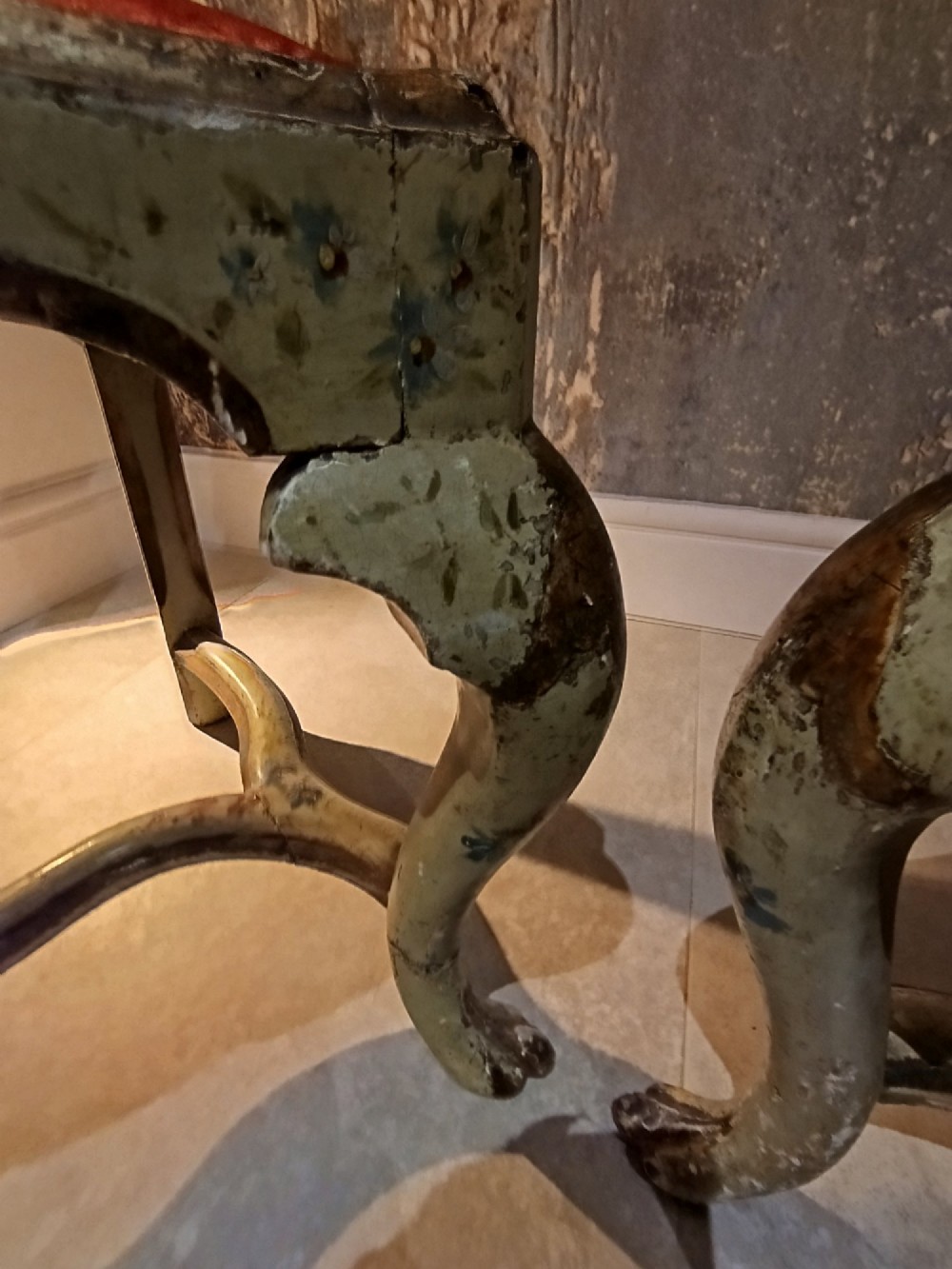 A pair of 18th-century North Italian side chairs featuring distressed cream painted frames with carved crests, cabriole legs, and red velvet seats. View VI