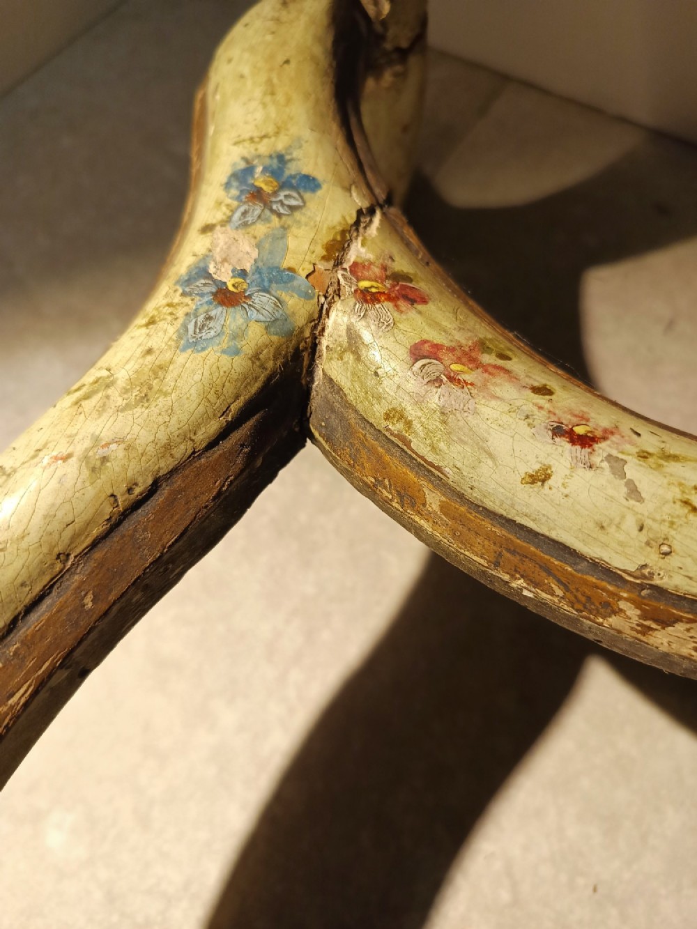 A pair of 18th-century North Italian side chairs featuring distressed cream painted frames with carved crests, cabriole legs, and red velvet seats. View XII