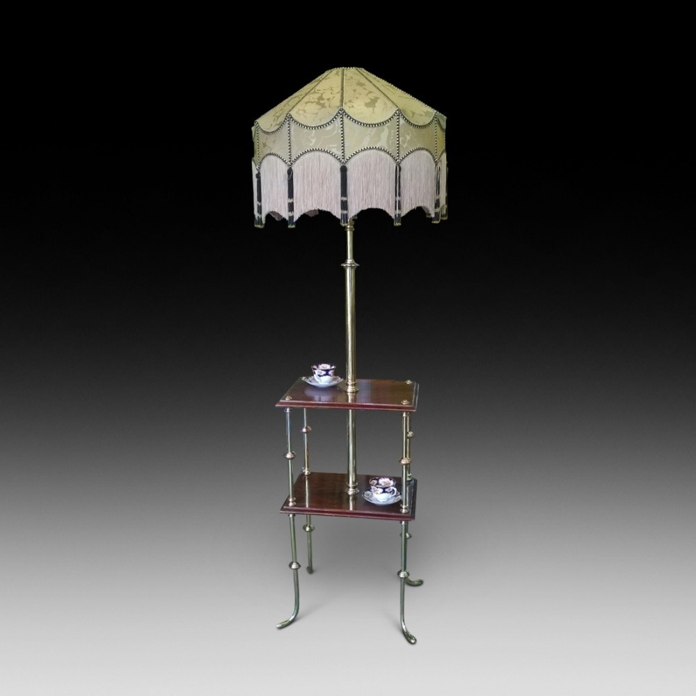 An Edwardian rosewood two tier standard lamp table