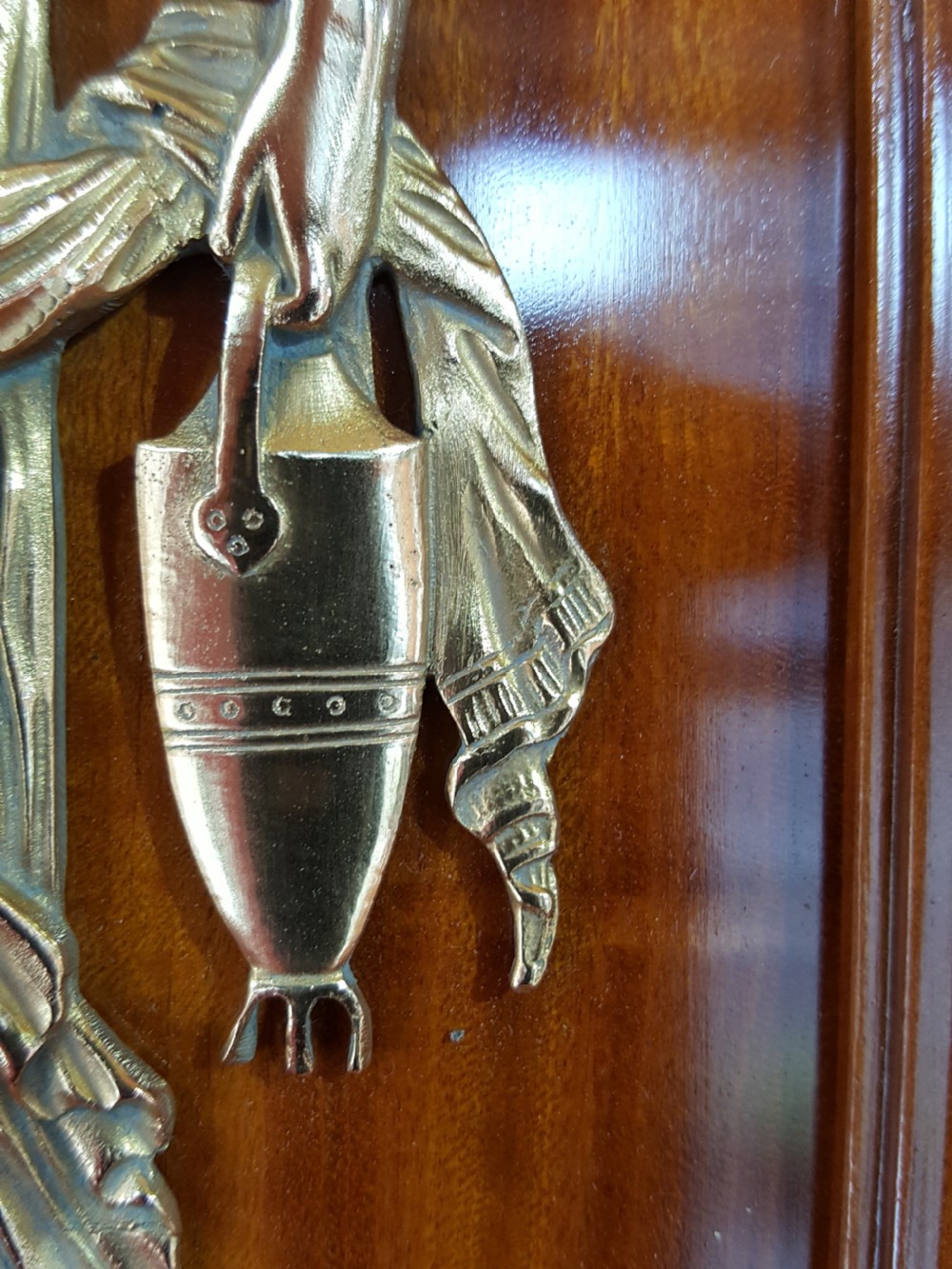 A tall late 19th-century Swiss satinwood salon cabinet featuring a pediment top, gilded metal mounts, glazed display compartments, central mirror, and inlaid door panels. View V