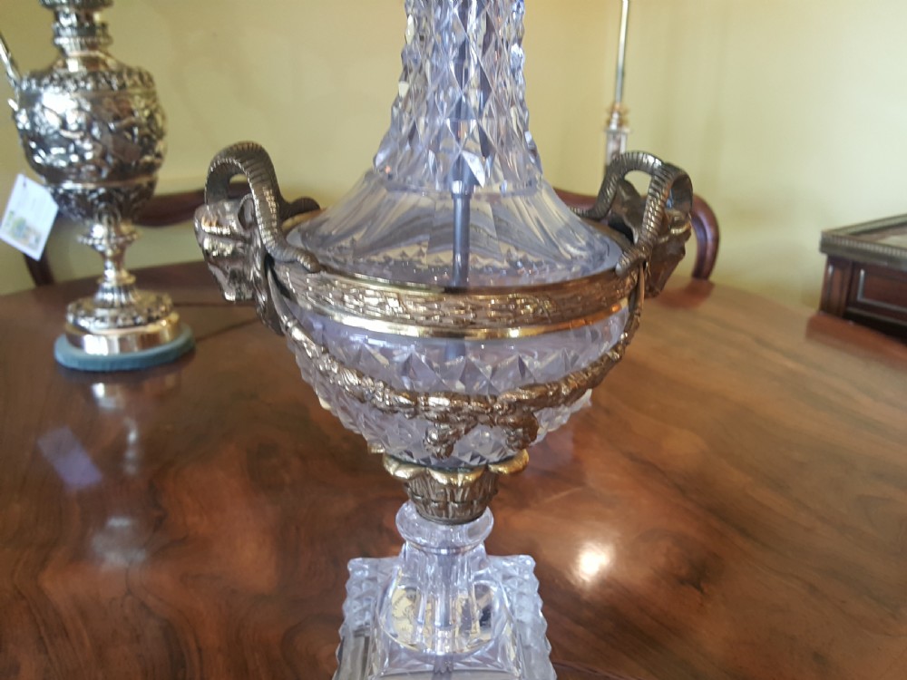 A cut glass urn-form table lamp with ornate gilt metal handles and base, topped with a black and gold patterned domed shade featuring long black fringe trim. View III