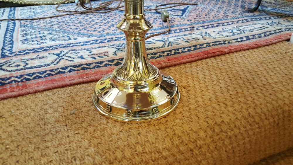 A pair of early 20thC brass candlesticks View II