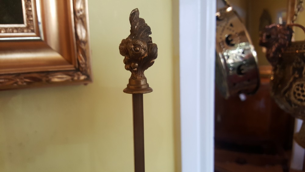 An early 20th-century French gilt bronze four-branch candelabrum converted into a table lamp, featuring hanging crystal drops, a central brass rod, and a black shade. View IV