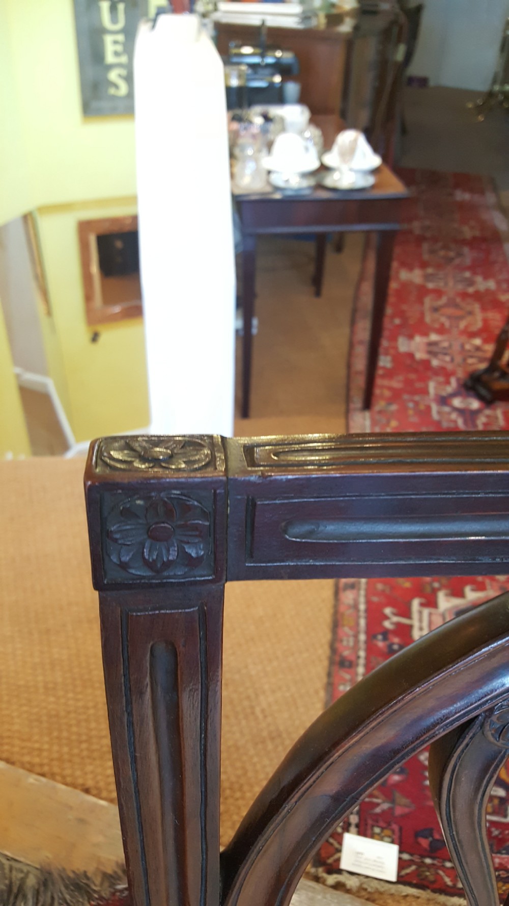 A set of four Regency mahogany side chairs featuring carved lyre back splats inside circular frame apertures, with off-white upholstered seats and fluted front legs. View III