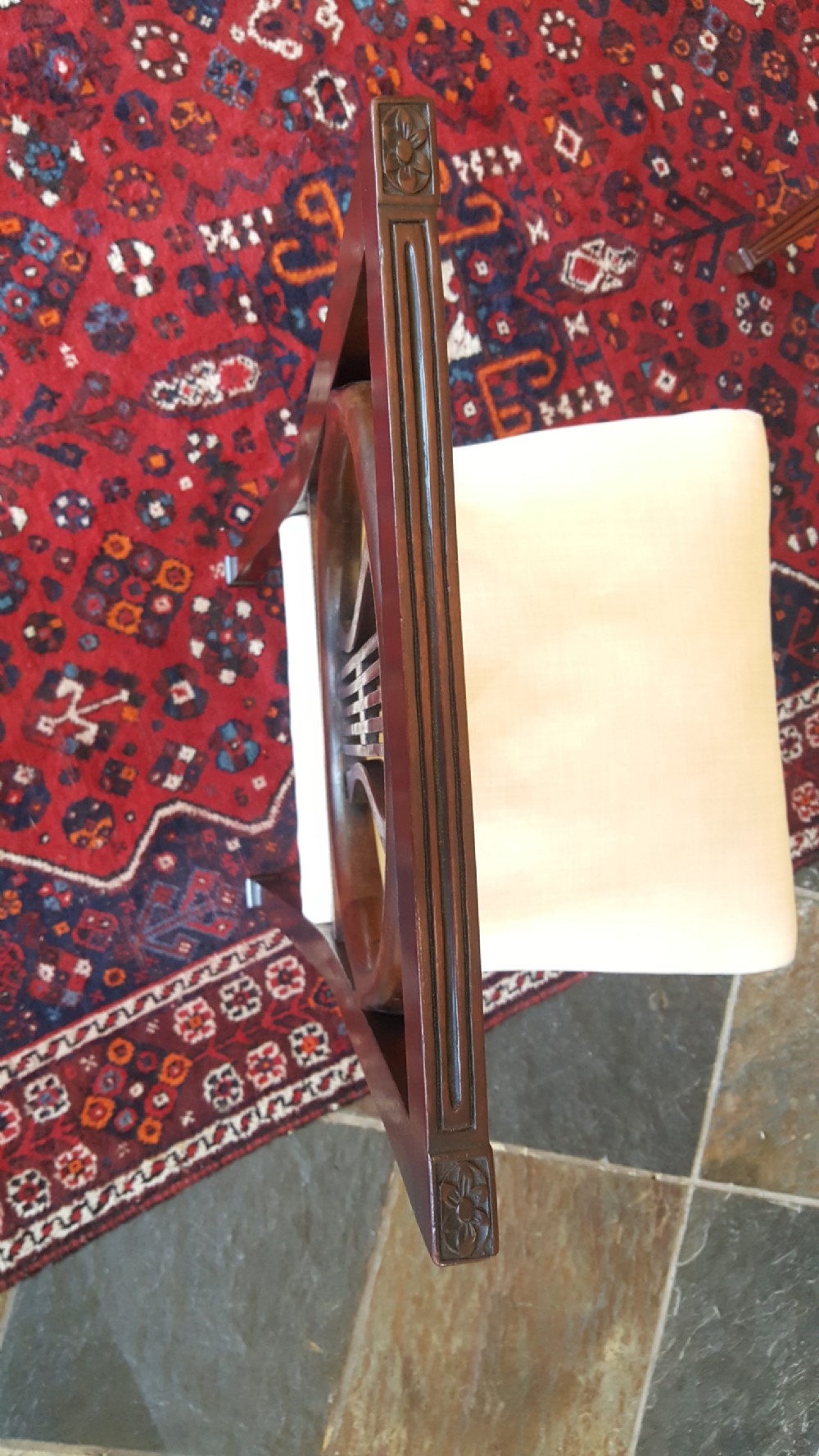 A set of four Regency mahogany side chairs featuring carved lyre back splats inside circular frame apertures, with off-white upholstered seats and fluted front legs. View VIII