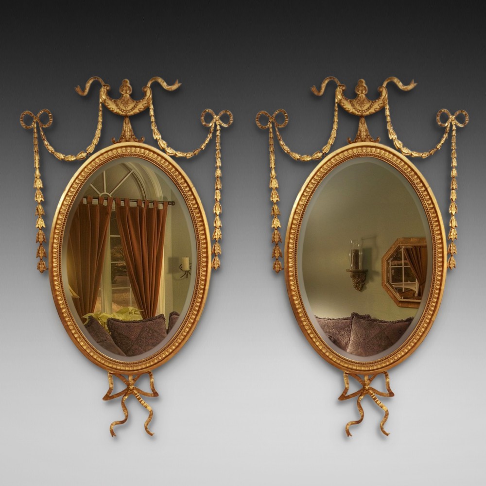 Pair of Edwardian Adam Revival carved gilt wood and gesso wall mirrors
