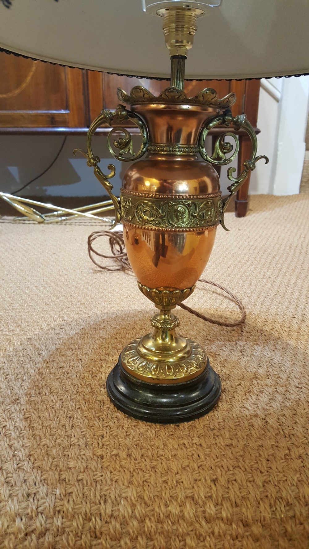 A pair of late 19th-century table lamps with urn-shaped copper and brass bases paired with blue tweed shades. View II