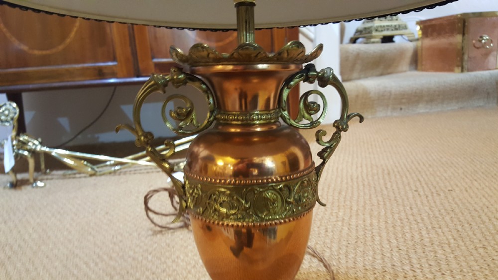 A pair of late 19th-century table lamps with urn-shaped copper and brass bases paired with blue tweed shades. View VIII