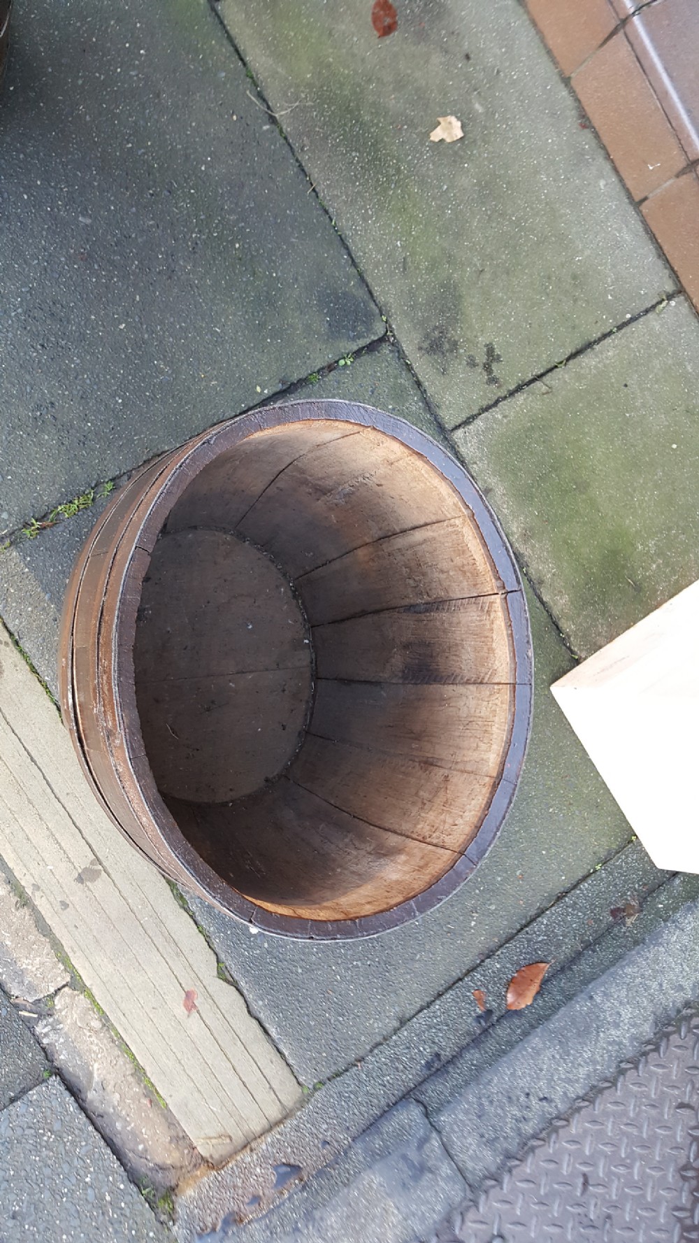 An early twentieth-century coopered oak barrel bound with dark iron hoops and featuring a central bung hole. View IV