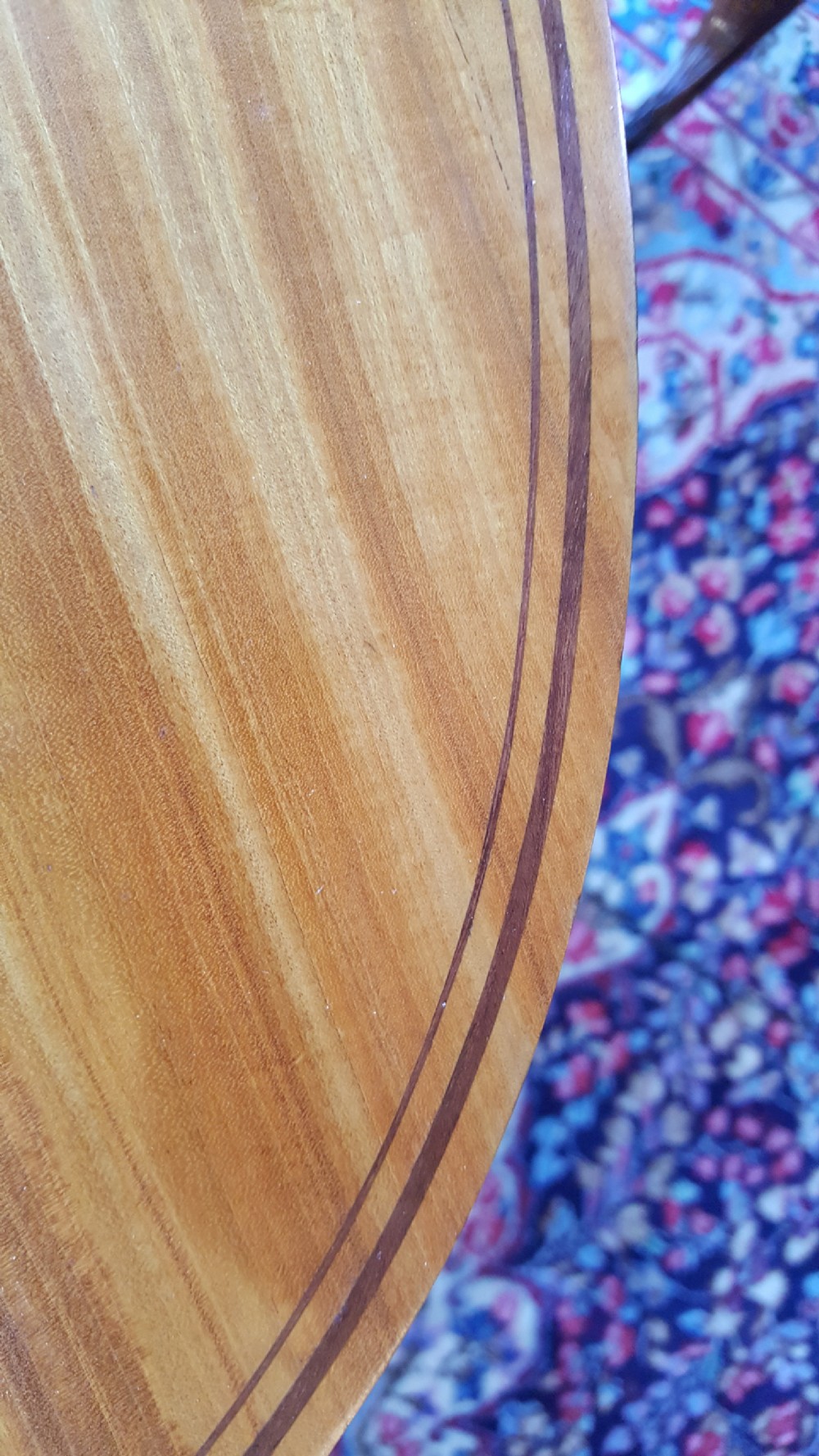 An Edwardian oval satinwood occasional table featuring slender square tapered legs, crossbanded inlay along the top edge, and a small oval lower undertier. View VI