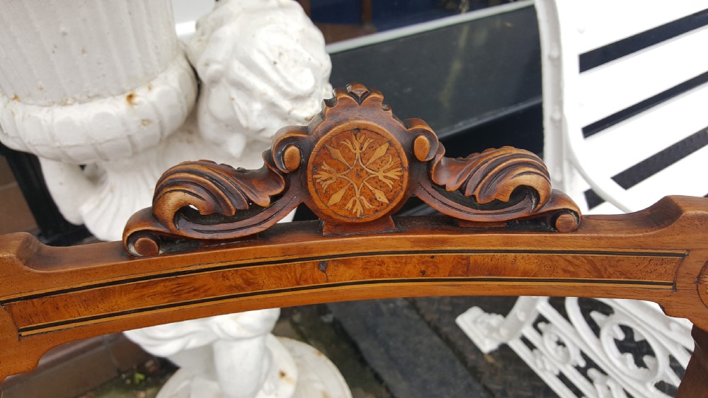 A set of four Victorian walnut salon chairs featuring carved rectangular open backs, turned front legs, and seats upholstered in dusty pink damask with braid trim. View II