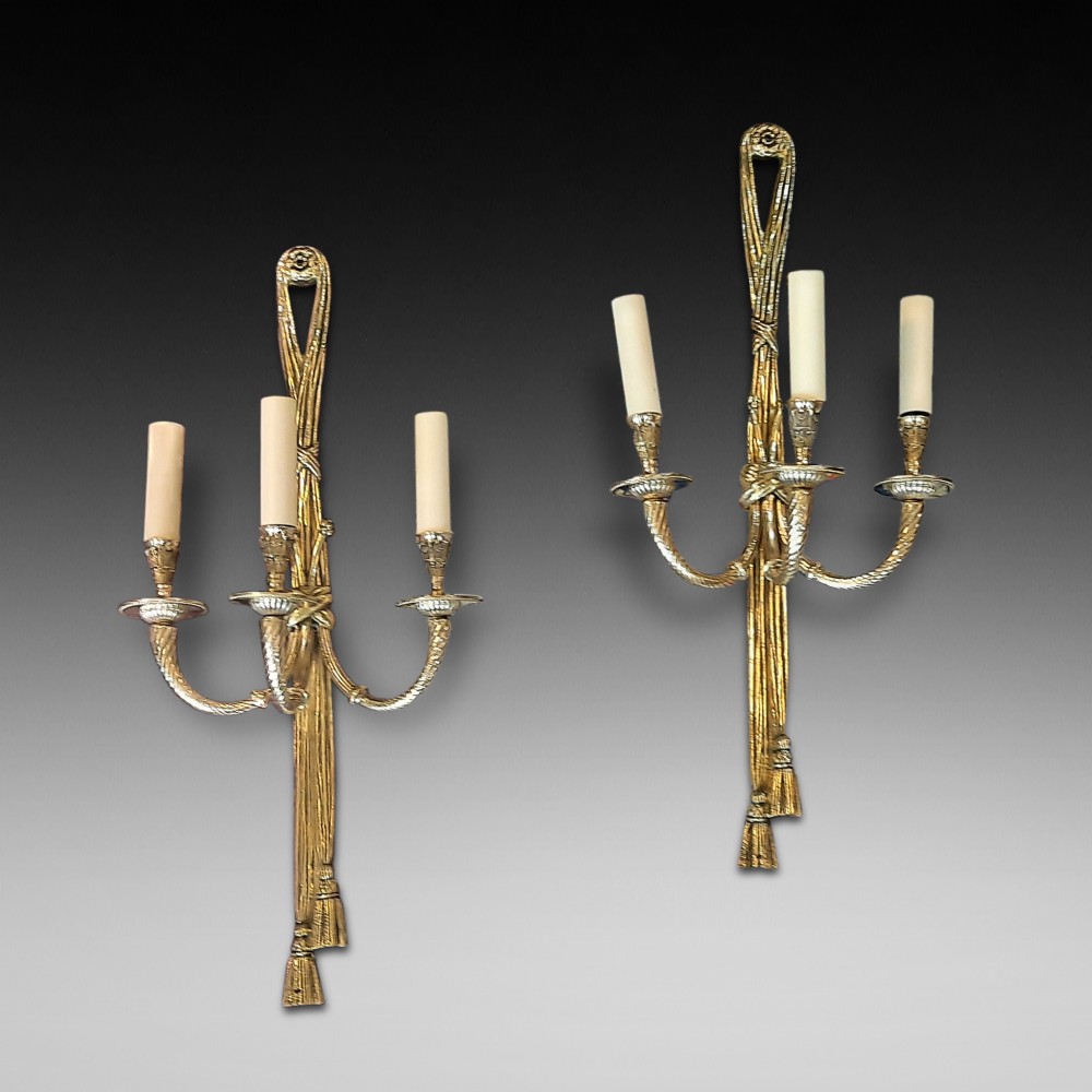 Pair of early 20thC gilt metal three branch wall light fittings