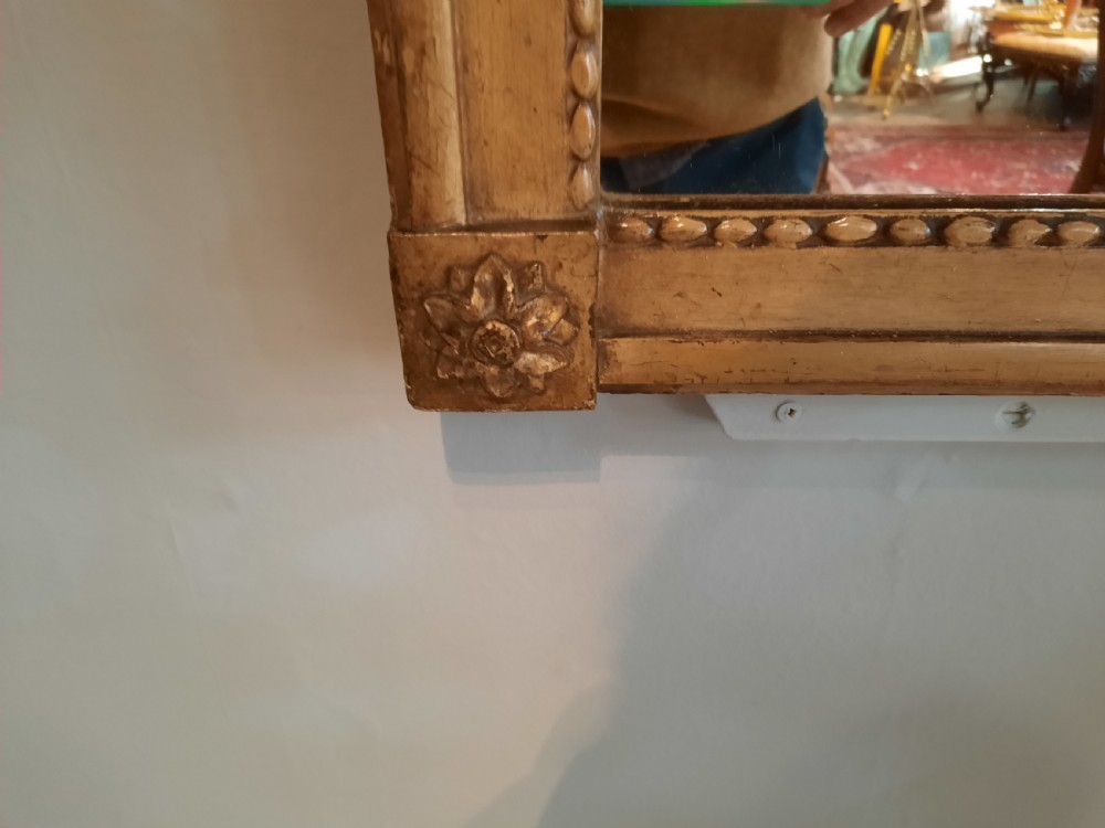 A tall 19th-century gilded composition trumeau mirror featuring an oil landscape painting set within the upper panel and a rectangular mirror plate below. View III