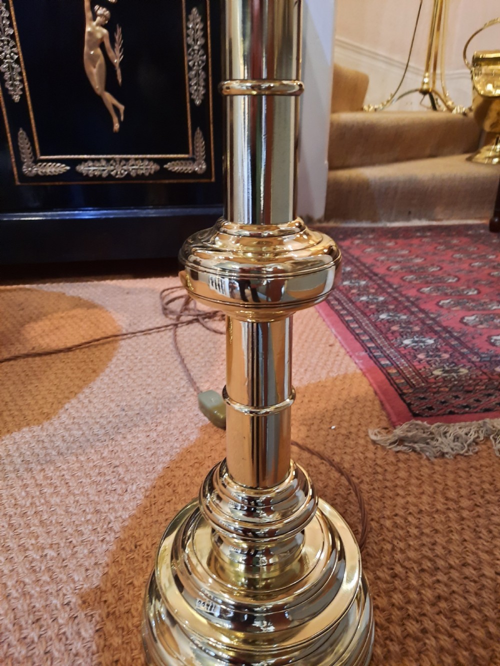 A pair of tall turned brass candlesticks fitted with dome-shaped beige fabric shades featuring scalloped fringe detail. View III