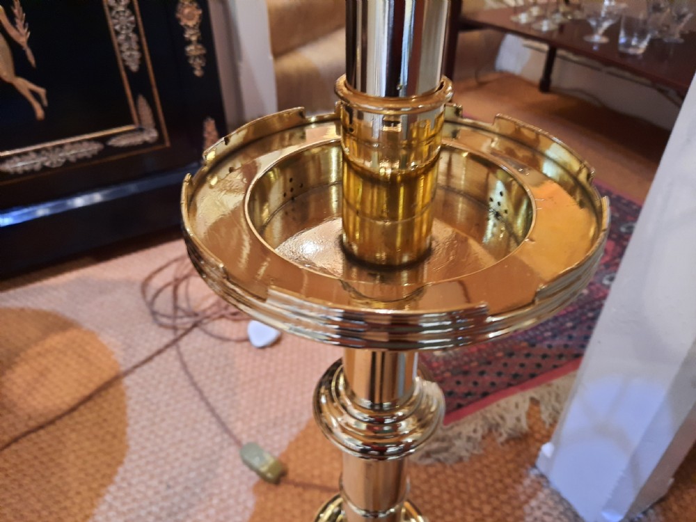A pair of tall turned brass candlesticks fitted with dome-shaped beige fabric shades featuring scalloped fringe detail. View VI