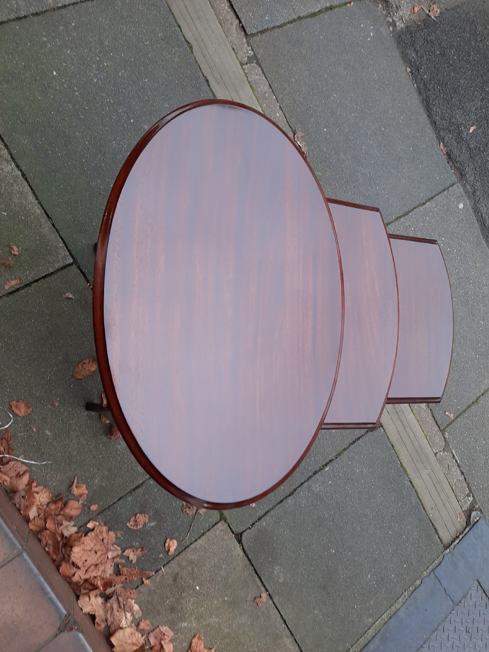 A graduated trio of early twentieth-century mahogany side tables with oval tops, slender legs, and perimeter stretchers. View II