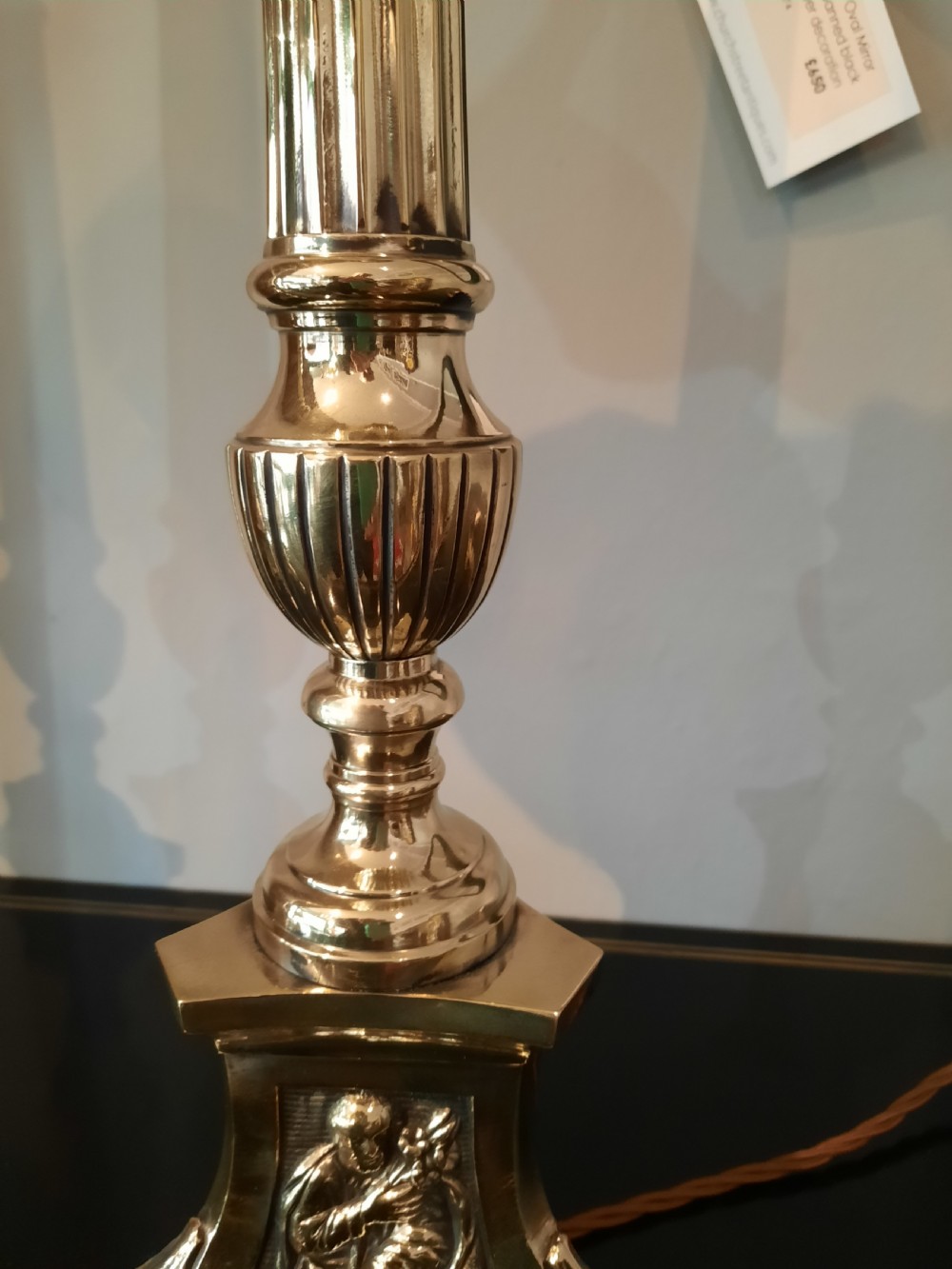 A matching pair of tall silver-plated table lamps styled as pricket candlesticks with fluted column shafts and decorated triform bases. View II