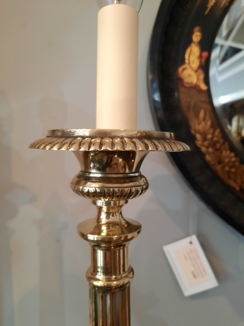 A matching pair of tall silver-plated table lamps styled as pricket candlesticks with fluted column shafts and decorated triform bases. View III