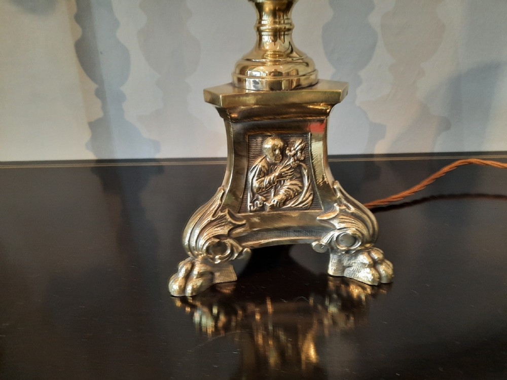 A matching pair of tall silver-plated table lamps styled as pricket candlesticks with fluted column shafts and decorated triform bases. View IV