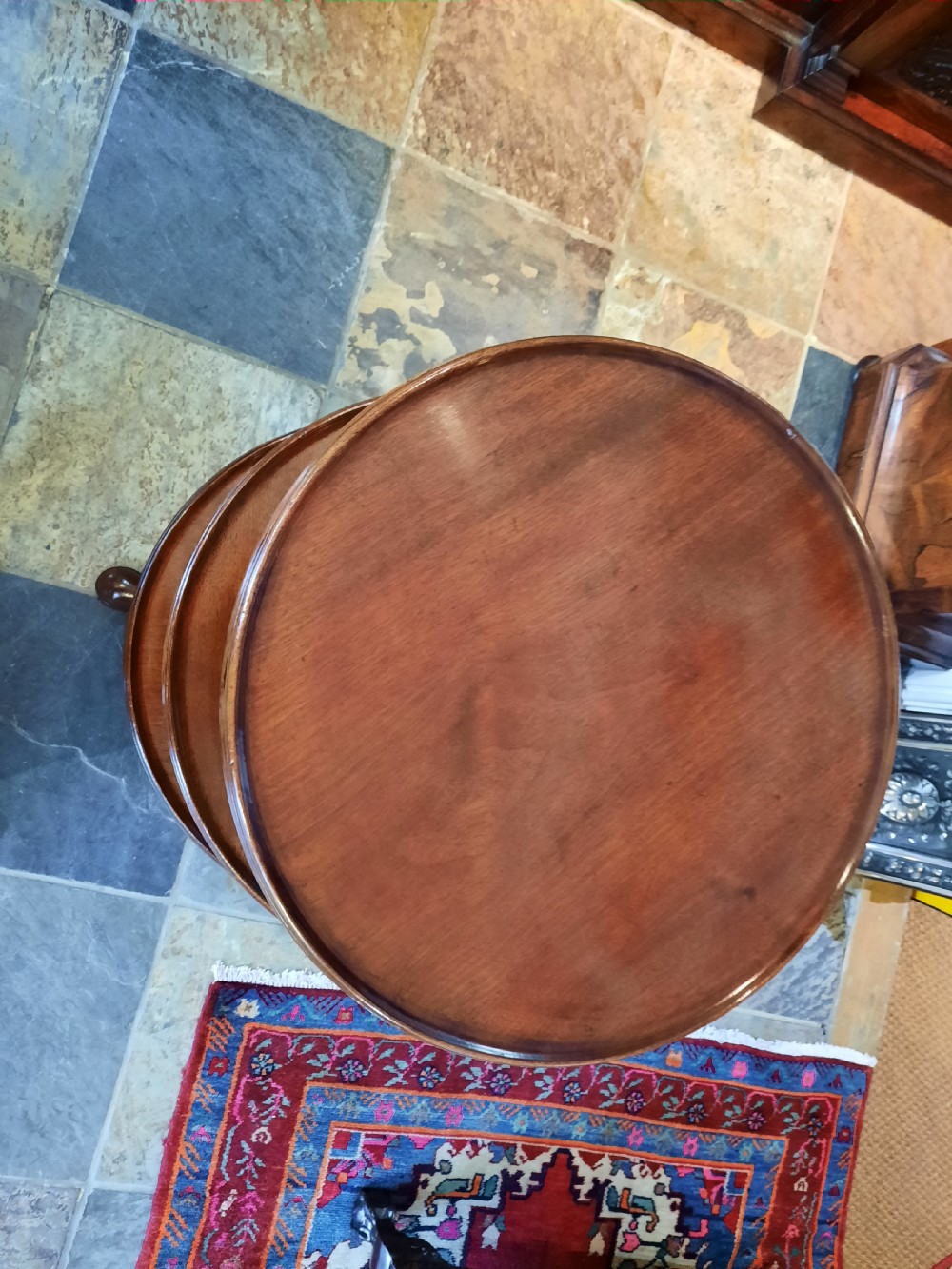 A George III mahogany three-tier dumb waiter featuring three graduated circular dished trays on turned supports and a tripod base. View II