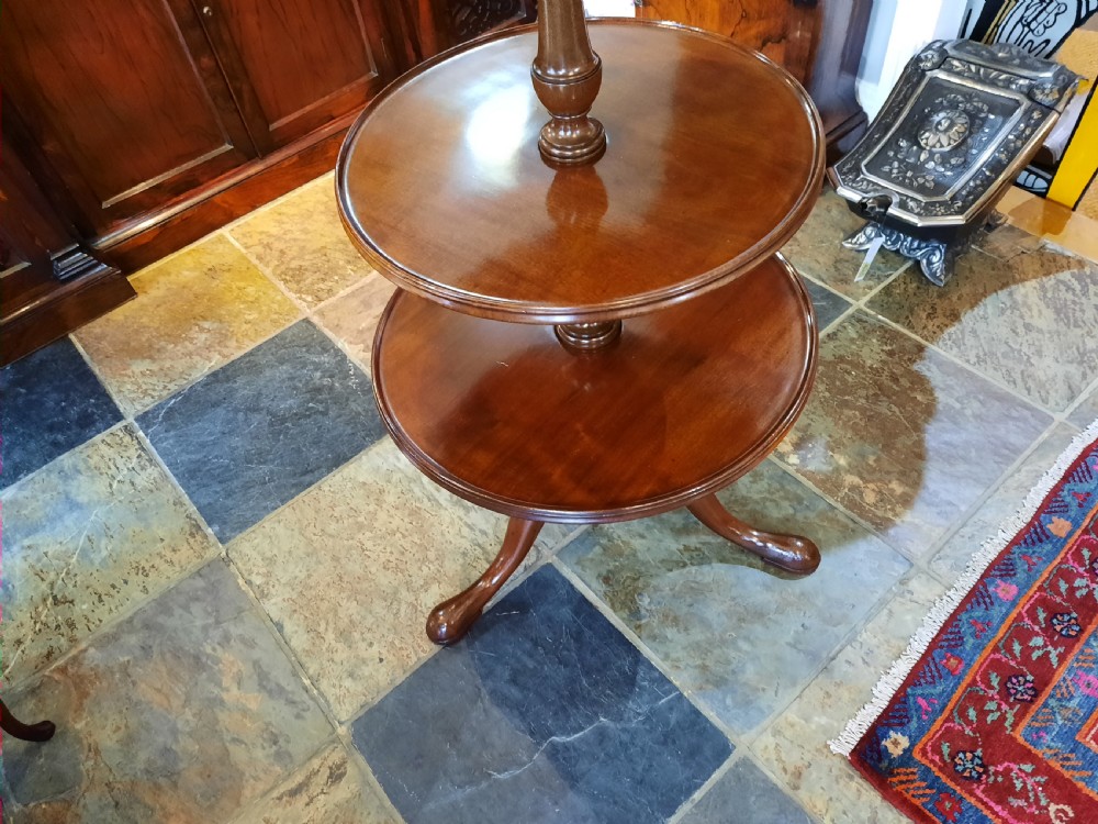 A George III mahogany three-tier dumb waiter featuring three graduated circular dished trays on turned supports and a tripod base. View III