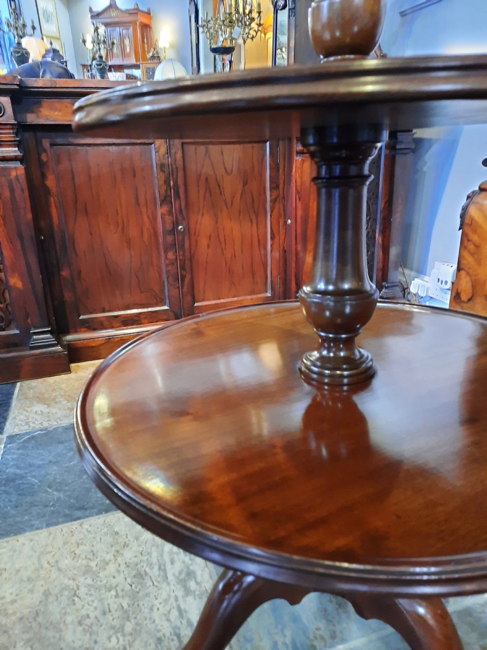 A George III mahogany three-tier dumb waiter featuring three graduated circular dished trays on turned supports and a tripod base. View IV