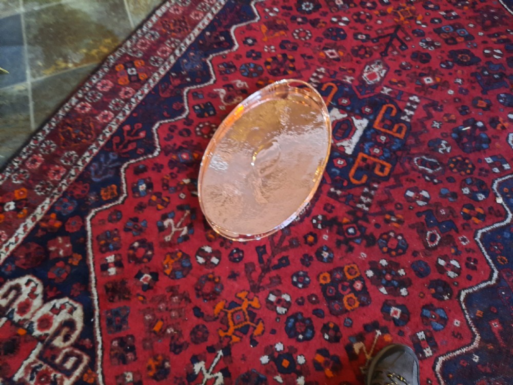 An oval Arts and Crafts hand-hammered copper tray with twin integrated handles and a central motif. View II
