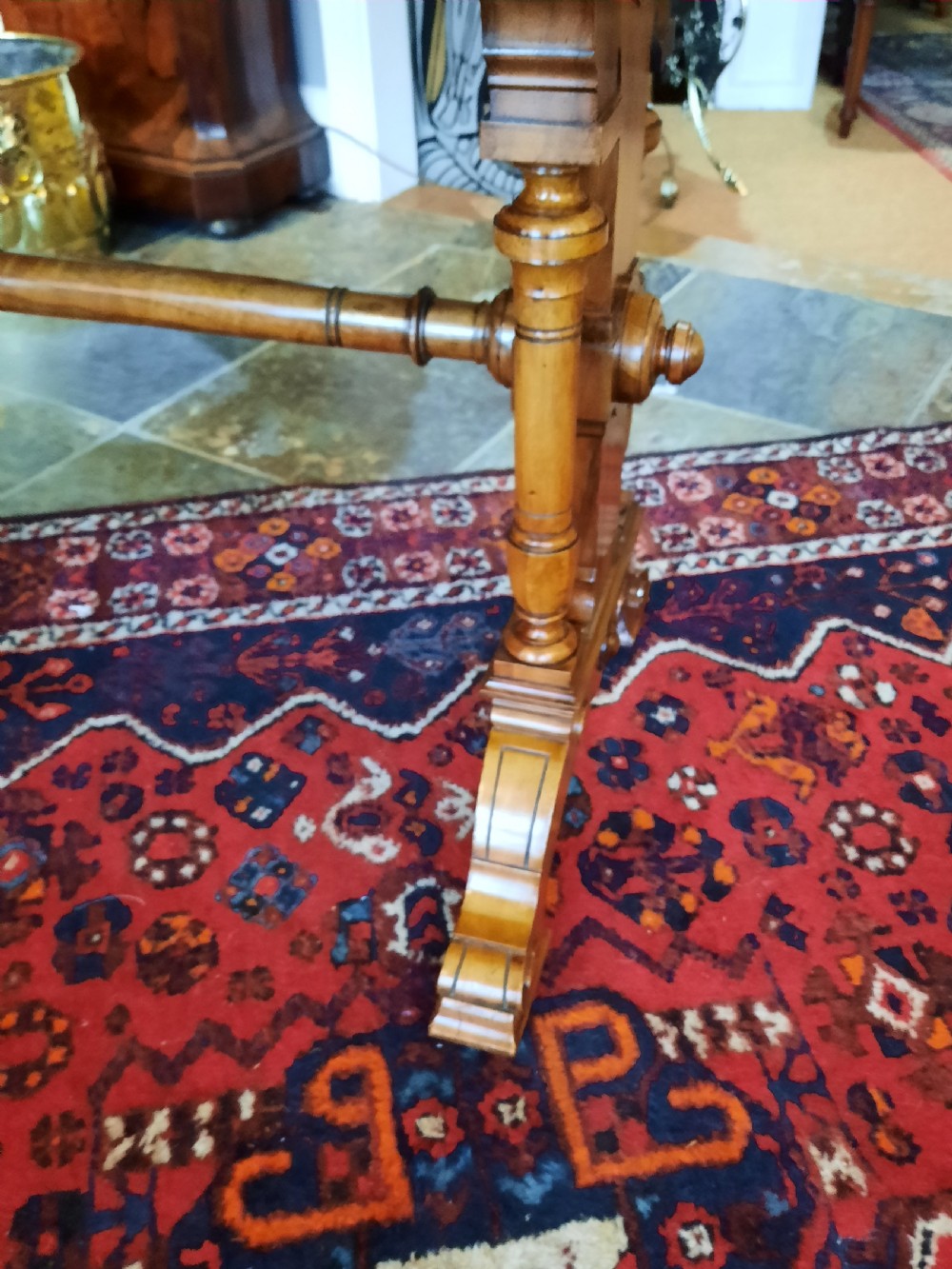 A Victorian walnut centre sofa table featuring a rectangular figured veneer top, turned stretcher, carved end supports, and dual feet. View III