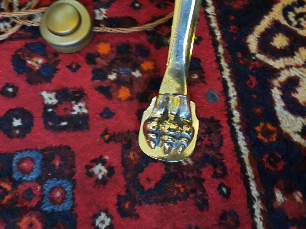 A late Victorian telescopic brass standard lamp featuring tripod scroll feet and a domed floral fabric shade with fringe trim. View V