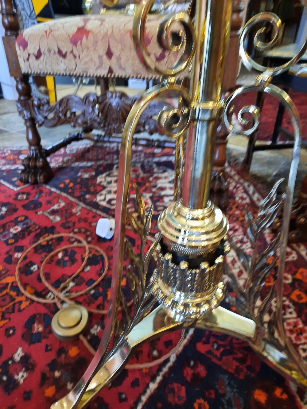 A late Victorian telescopic brass standard lamp featuring tripod scroll feet and a domed floral fabric shade with fringe trim. View VI