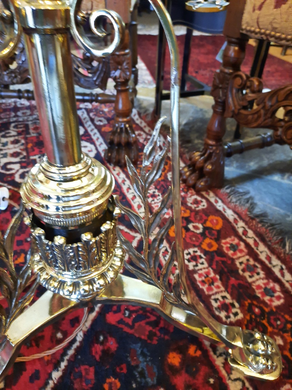 A late Victorian telescopic brass standard lamp featuring tripod scroll feet and a domed floral fabric shade with fringe trim. View VII