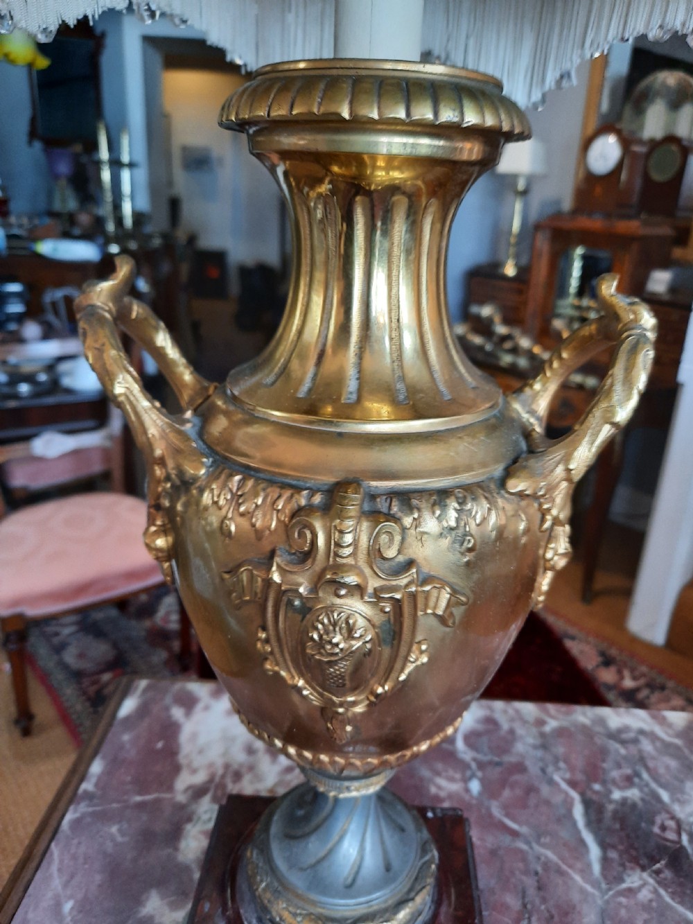 A 19th-century gilt bronze classical urn mounted as a table lamp on a square marble base with a fringed fabric shade. View IV
