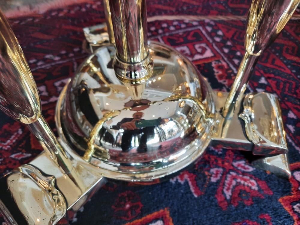 An early 20th-century Art Nouveau brass standard lamp featuring openwork base detailing and a patterned terracotta lampshade with fringe and tassels. View IV