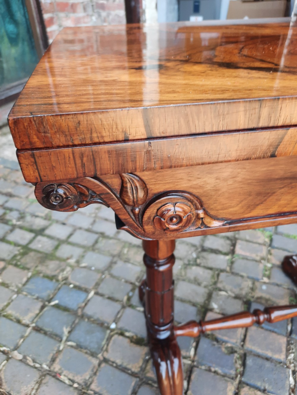 A 19th-century rosewood card table with a fold-over rectangular top, carved scroll apron, turned supports, and carved claw feet. View IV