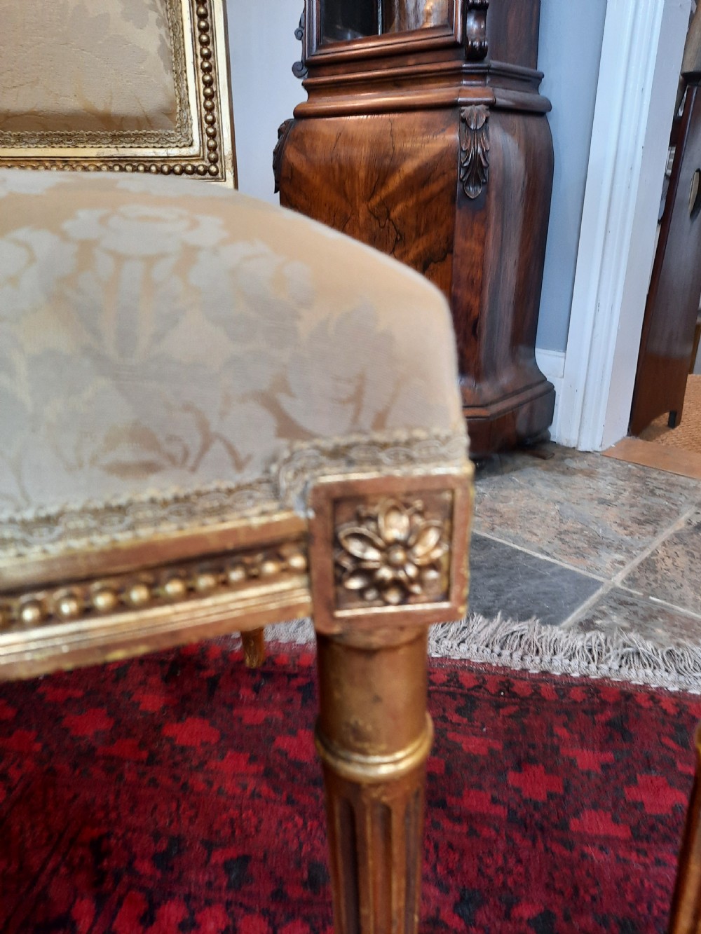A pair of Victorian giltwood salon chairs featuring fluted legs and pale cream damask upholstery. View II