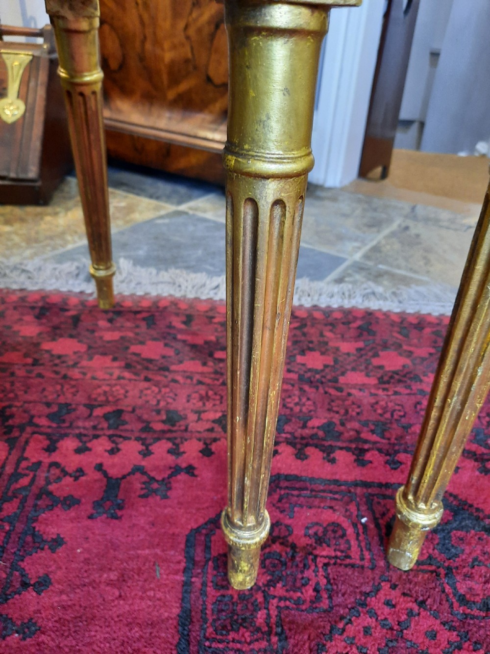 A pair of Victorian giltwood salon chairs featuring fluted legs and pale cream damask upholstery. View V