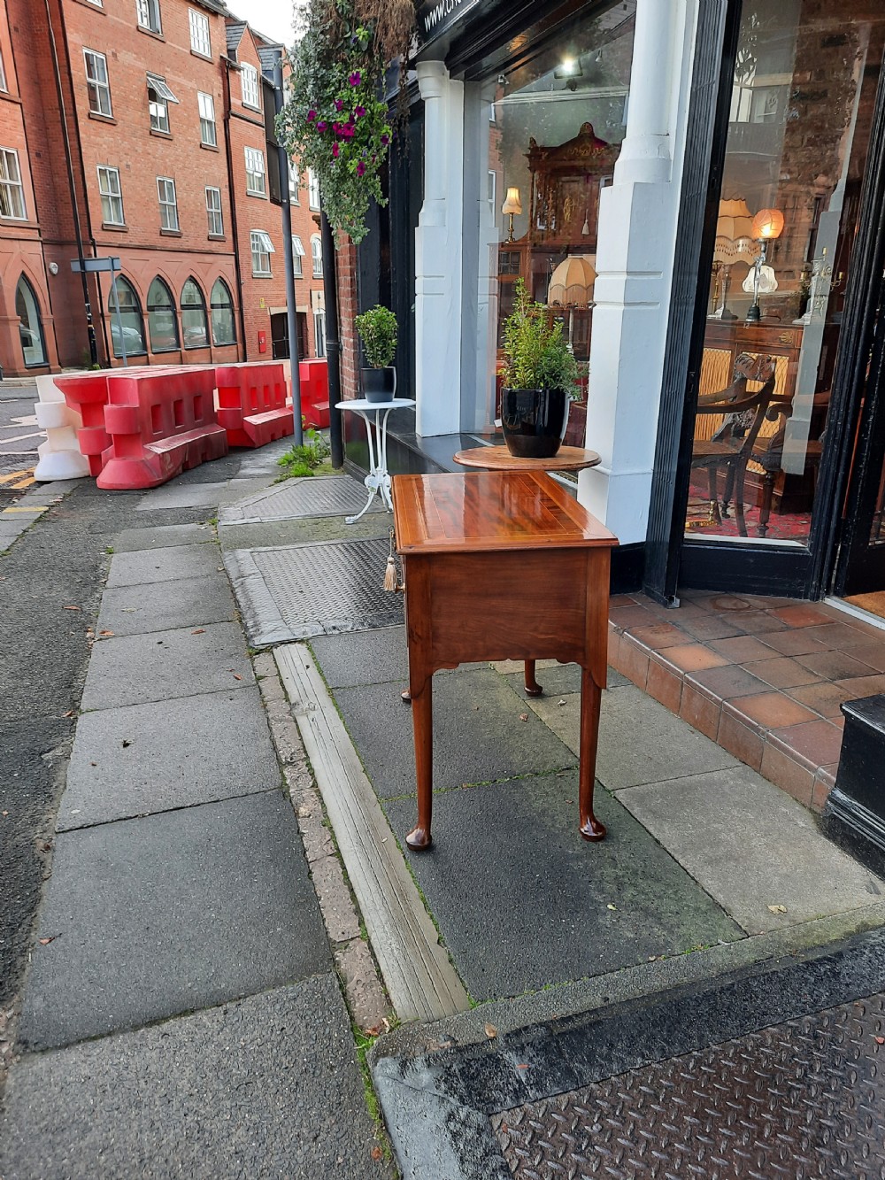 An Edwardian inlaid mahogany lowboy featuring three drawer fronts decorated with lighter wood inlay, an arched apron, and cabriole legs. View VIII
