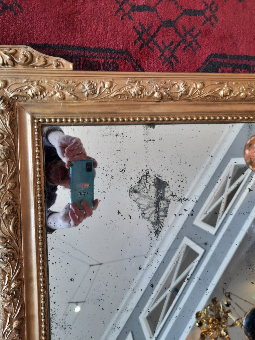A rectangular 19th-century giltwood and gesso wall mirror featuring ornate foliate moulding and original foxed mirror glass. View III
