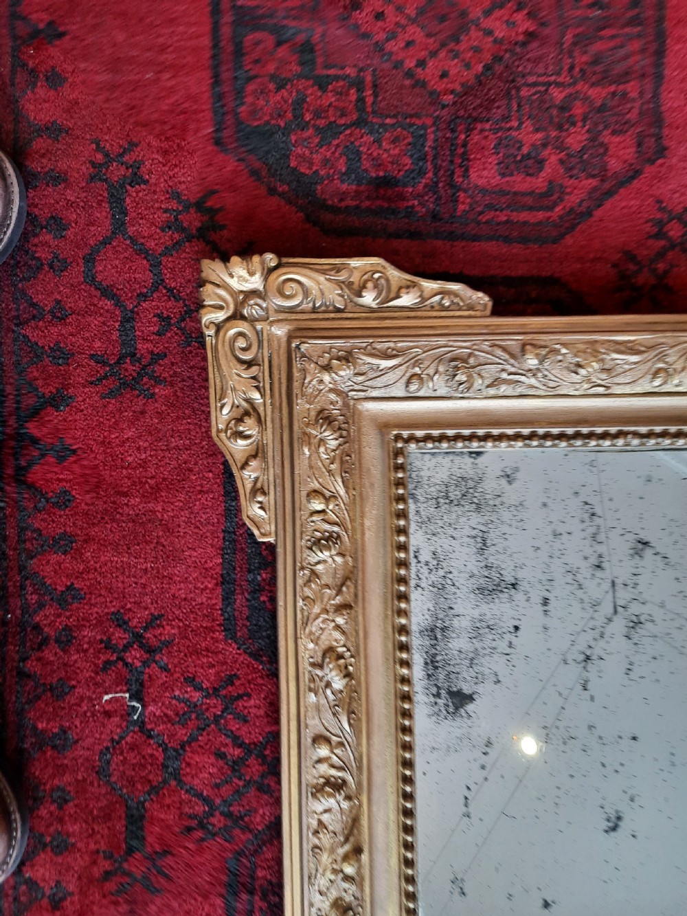 A rectangular 19th-century giltwood and gesso wall mirror featuring ornate foliate moulding and original foxed mirror glass. View IV