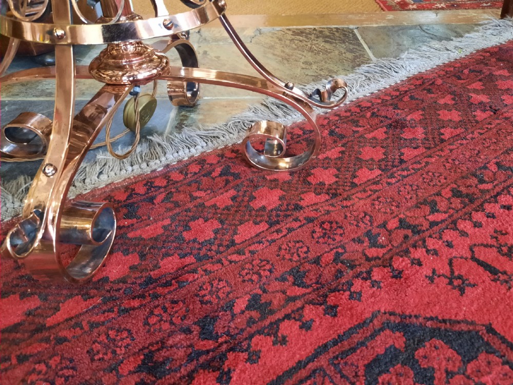 An Arts and Crafts copper floor lamp featuring an adjustable central stem, scrollwork base, and a patterned fabric shade. View II