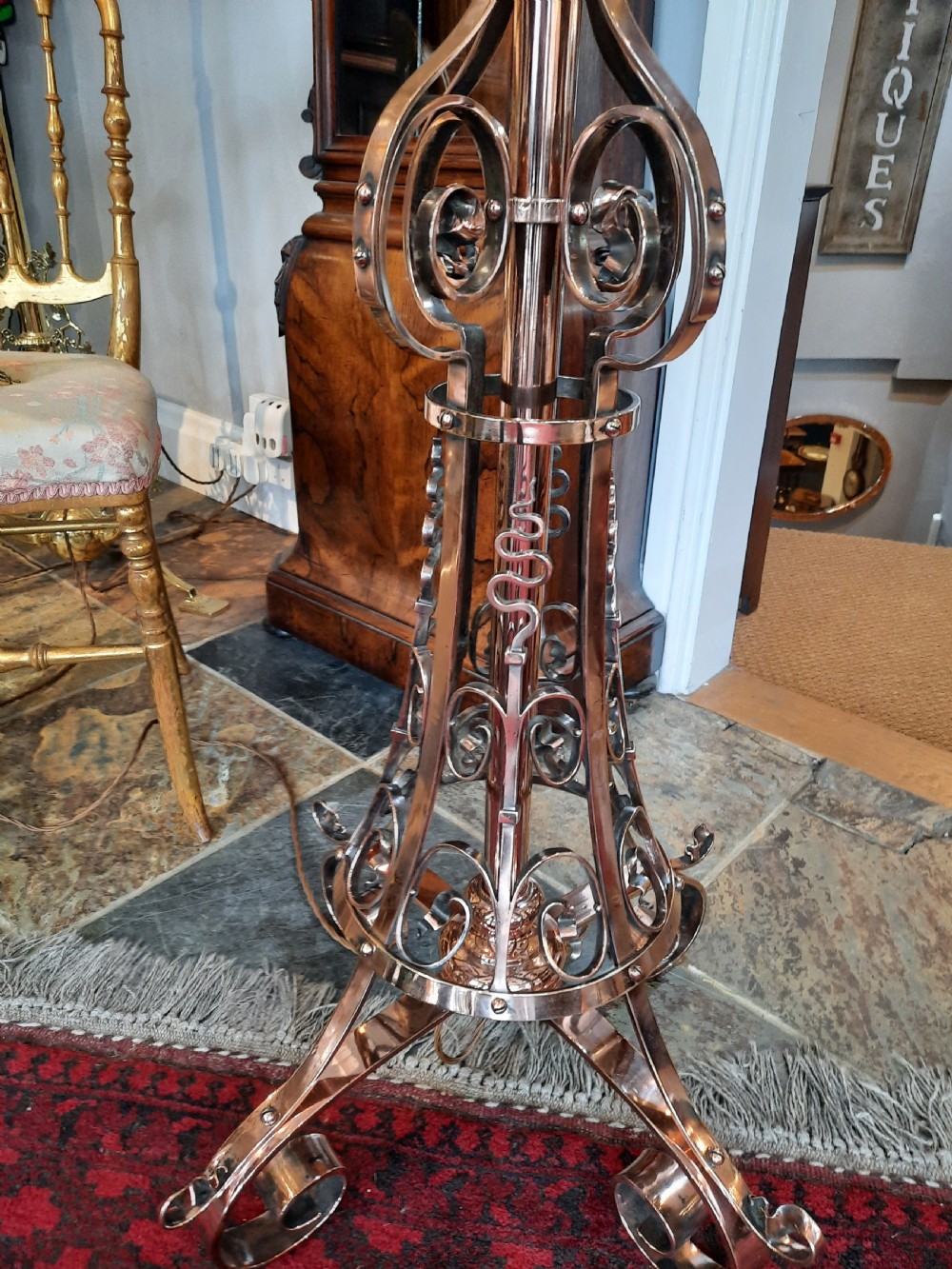 An Arts and Crafts copper floor lamp featuring an adjustable central stem, scrollwork base, and a patterned fabric shade. View III