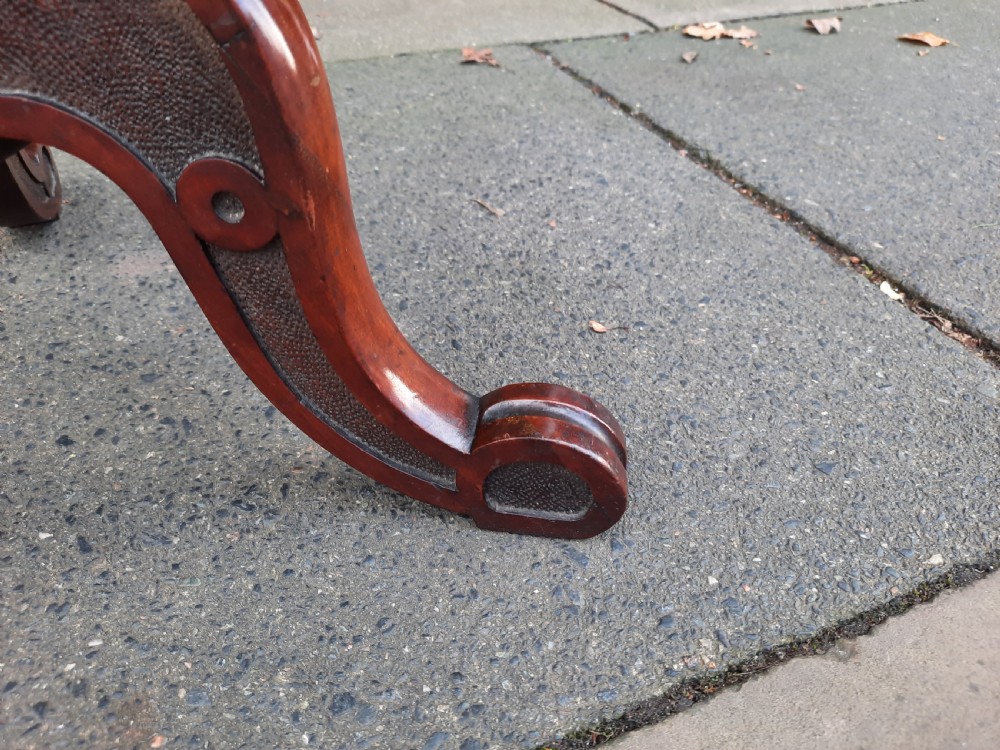 A Victorian mahogany occasional table featuring a circular top, turned central pedestal stem, and three curved tripod feet. View III