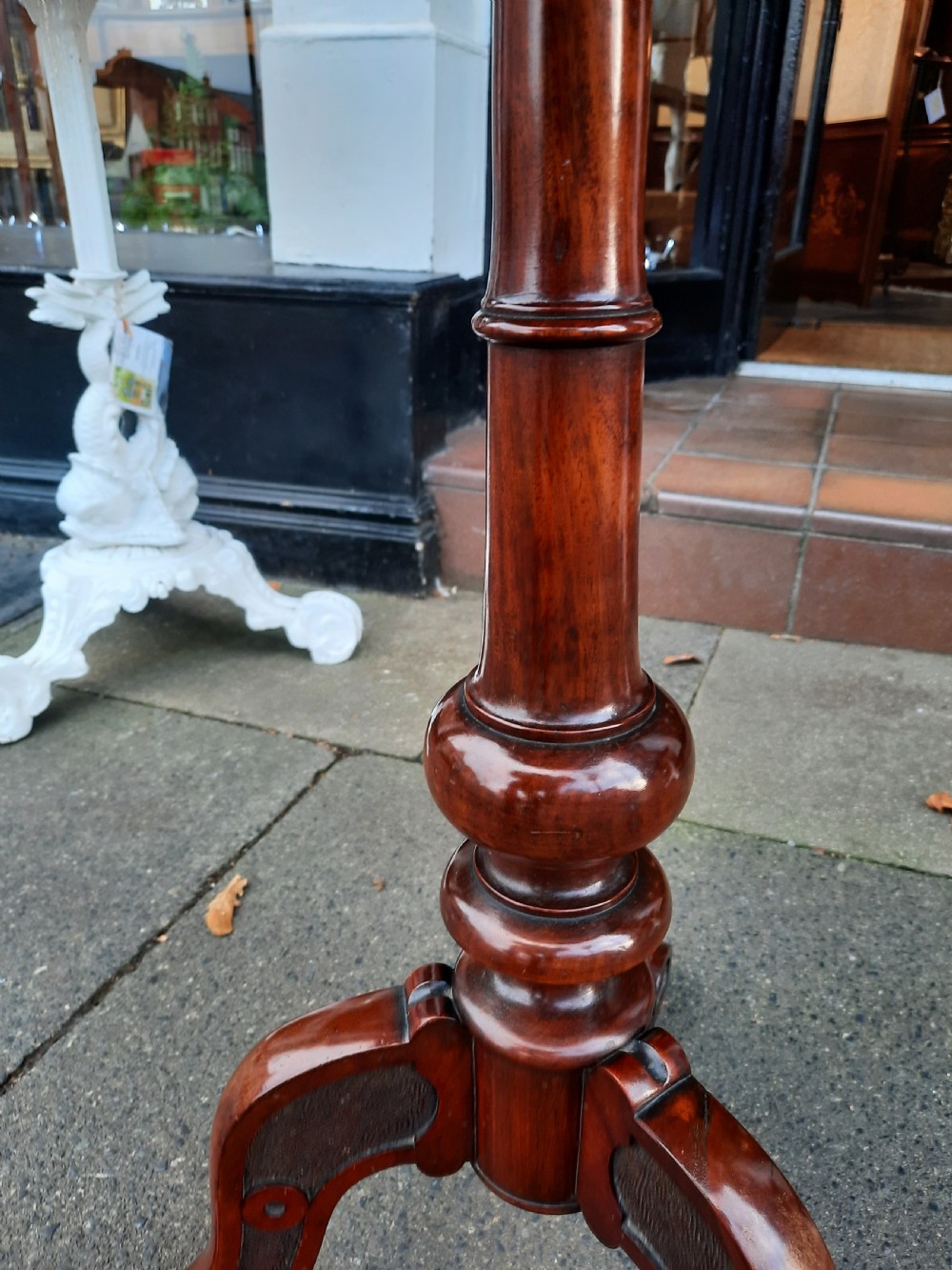 A Victorian mahogany occasional table featuring a circular top, turned central pedestal stem, and three curved tripod feet. View IV